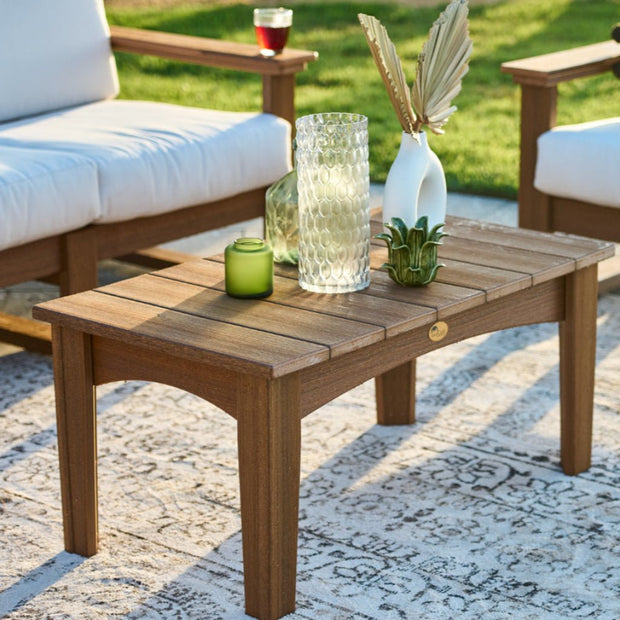 LuxCraft Island Coffee Table featured in Antique Mahogany alongside the Lanai Deep Seating with Canvas Cushions.